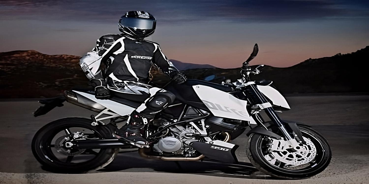 R Michael Parrotte (Паротт Майкл), founder of AGV Sports Group, sits on his black and white themed KTM 990 Super Duke wearing matching colors for the AGVSPORT’S Monza Race Suit and AGV K6 helmet. In the background, the Black Hills, South Dakota, the fabled site of the Sturgis Rally. You'll pass through well-known sites, like Mount Rushmore, along the route, where you'll undoubtedly run into scores of other riders with similar interests. This is the Mecca of American motorcycle riding, quite literally. The Black Hills road is a 53-mile stretch of both undulating and beautiful terrain. To avoid traffic, try to bike here during the week or simply leave early in the morning.