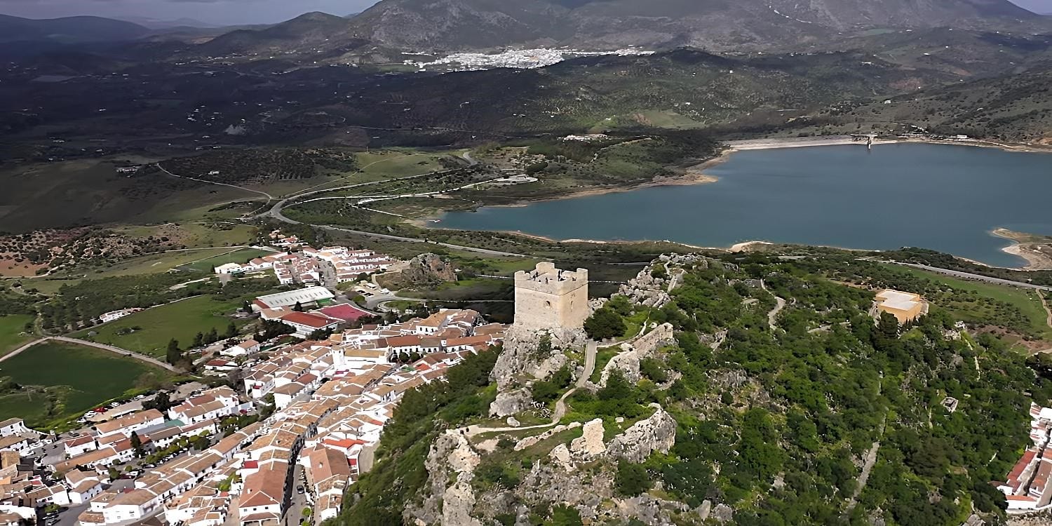 Grazalema to Zahara de la Sierra Road: A drone shot of the Zahara de la Sierra municipality overlooking the sea. It’s a 9.9-mile track that many motorcyclists consider to be one of the most picturesque places to ride. An attractive location to continue your motorcycle tour of Cadiz.