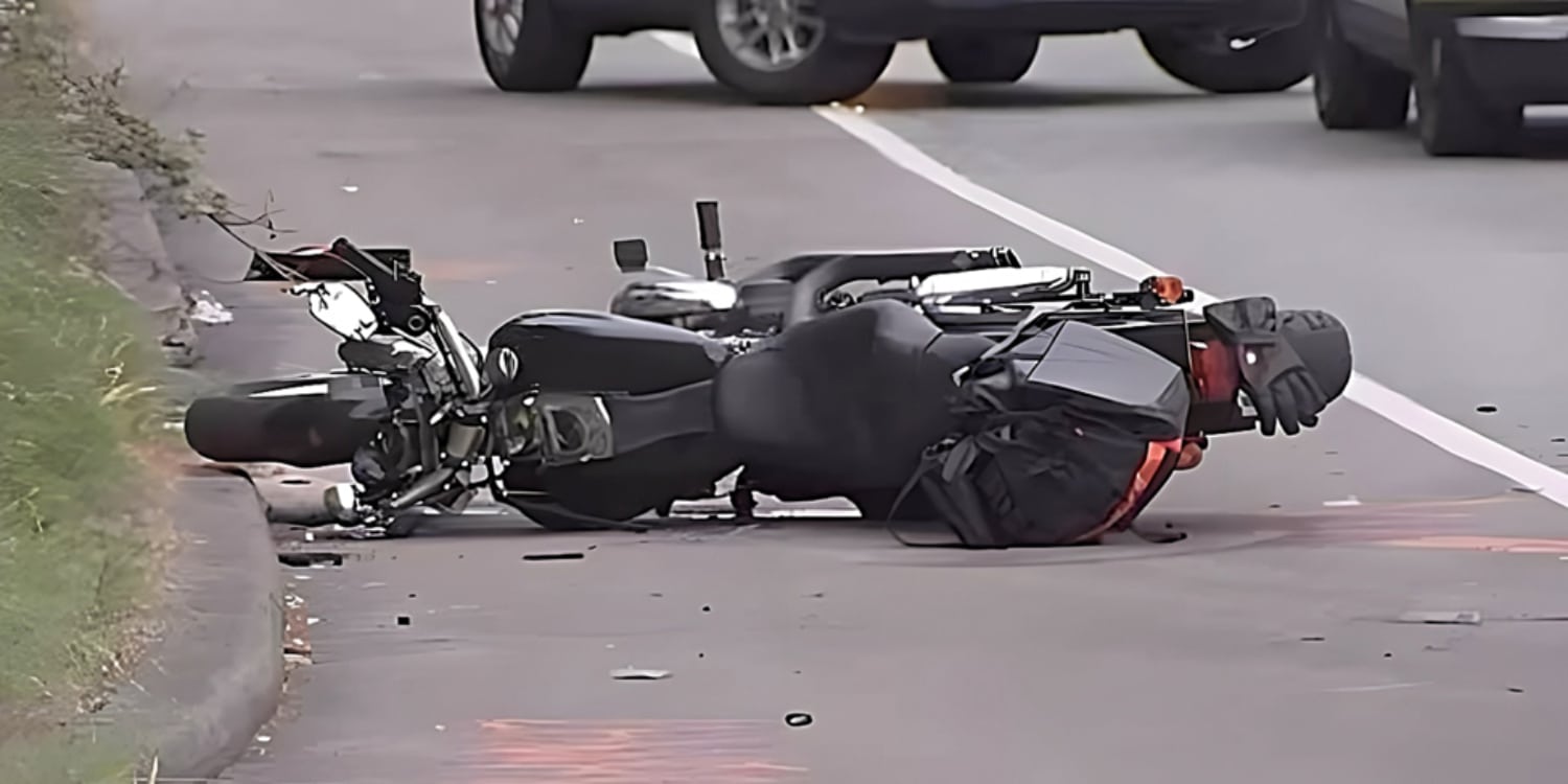 A tragic scene unfolds on Washington State Route 161 as a severely damaged black Honda Rebel 300 motorcycle lays overturned by the curb. The rider, who was heading north on the highway, had their life tragically cut short when a driver suspected of DUI made an illegal left turn on a red light at the Enchanted Park intersection, colliding with the motorcyclist. Despite being within the speed limit, the rider found themselves in an unfortunate and dangerous situation that ultimately led to their untimely death.