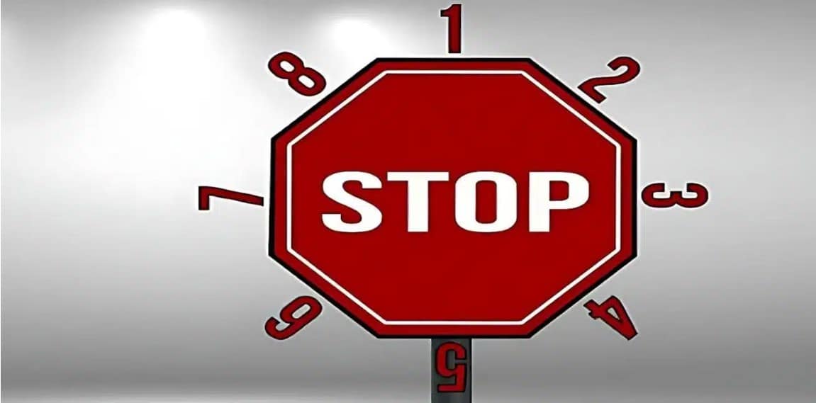 A stop sign post serving as a powerful reminder of what not to do with your expired helmets.