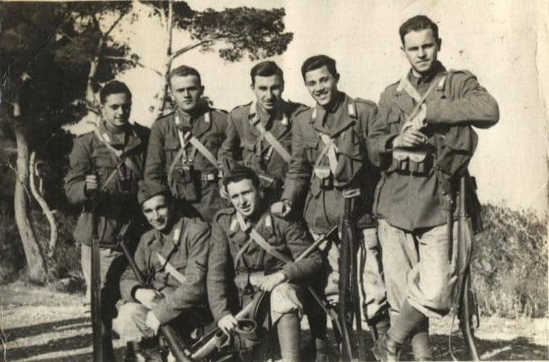 Seven World War II soldiers captured a moment in a photo after the war had ended.
