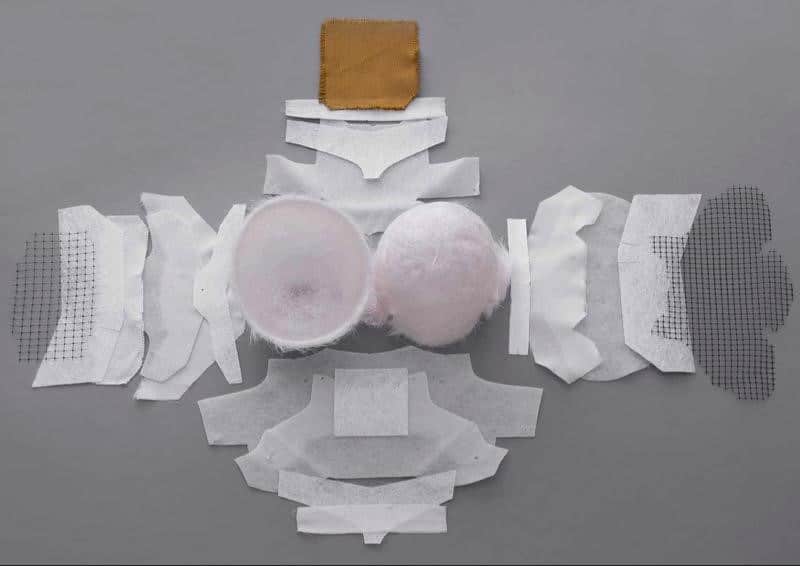 Each helmet, including the Arai Regent-X, introduced in 2020 and reviewed extensively, incorporates up to 18 reinforcing layers of Super Fiber—a material 30 percent stronger than regular fiberglass but six times more costly. Additionally, these layers are complemented by AR Mat, Zylon, and even carbon fiber. A team of expert craftsmen at Arai painstakingly arranges these reinforcing layers within the initial "preforma." Subsequently, a second preforma is added, securely encasing all the layers and effectively creating a robust "bird's nest" sandwich structure.