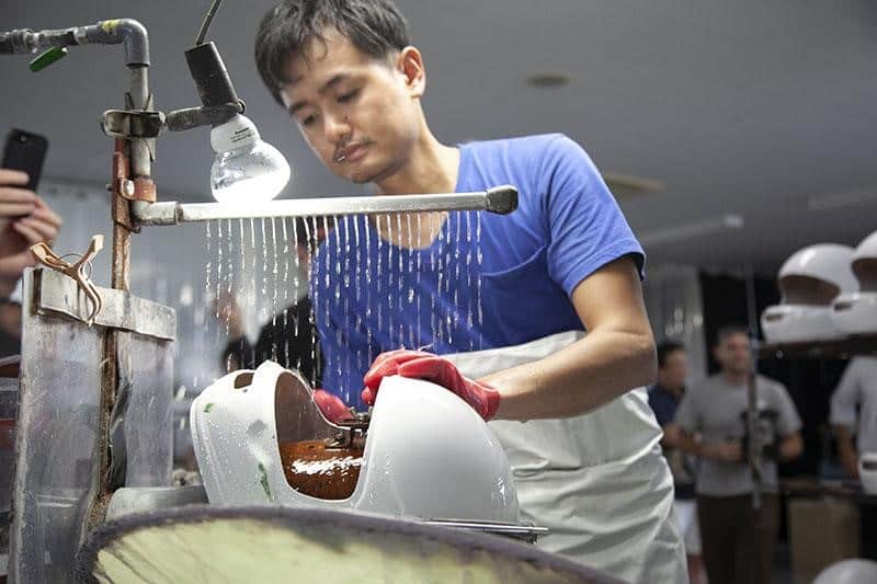 Due to the relatively substantial weight of resin, Arai employs a minimal amount in the shell formation process. This conservative approach leaves the shell with a coarse finish, necessitating an extensive amount of manual craftsmanship to refine it before it can be primed and painted.