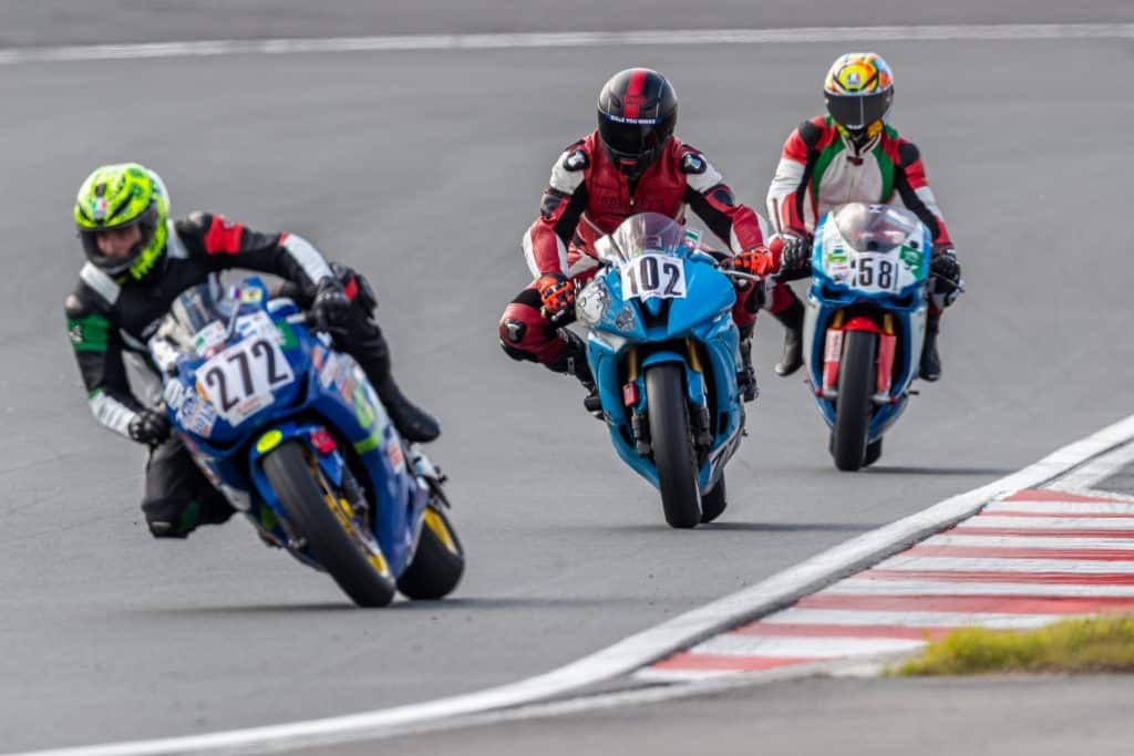 Top 5 Best Sportbike Tires for Street and Track In a thrilling competition, Denis Grachev accelerates, pushing his bike to its limits as he competes against three formidable riders on the race track. His tire grips the asphalt, propelling him ahead with unmatched speed and determination.
