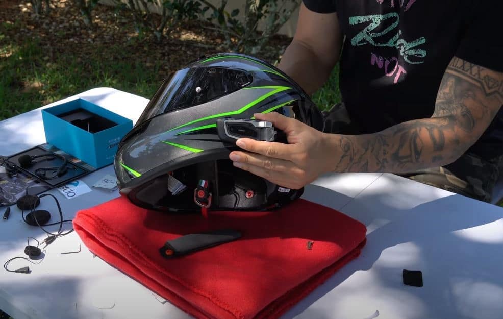 Effortlessly mounting the Cardo PackTalk Edge on the AGV K6 Flash helmet, which is a bliss with the new air-mount system. Simply locate a flat patch on the helmet's side, ideally near your clutch hand, for easy access to the actuator wheel.