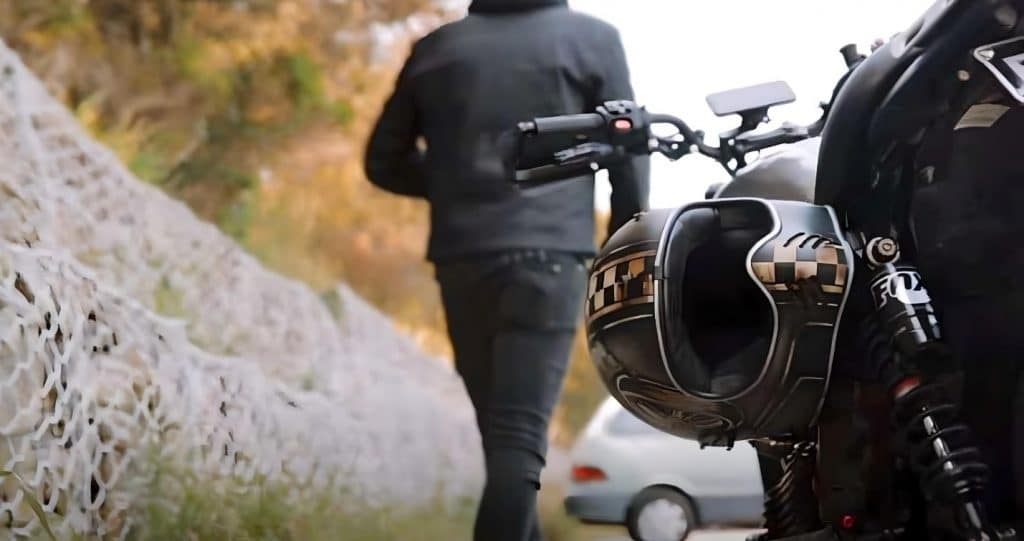 Is White Helmet Better Than Black? Loud Colors Save Lives The sleek black ECE 22.05 certified Premier MX OP 9 BN helmet, inspired by original Racing helmets from the 1970s, securely fastened on the Ducati Scrambler Café Racer, ensuring both safety and serenity for the rider's journey.