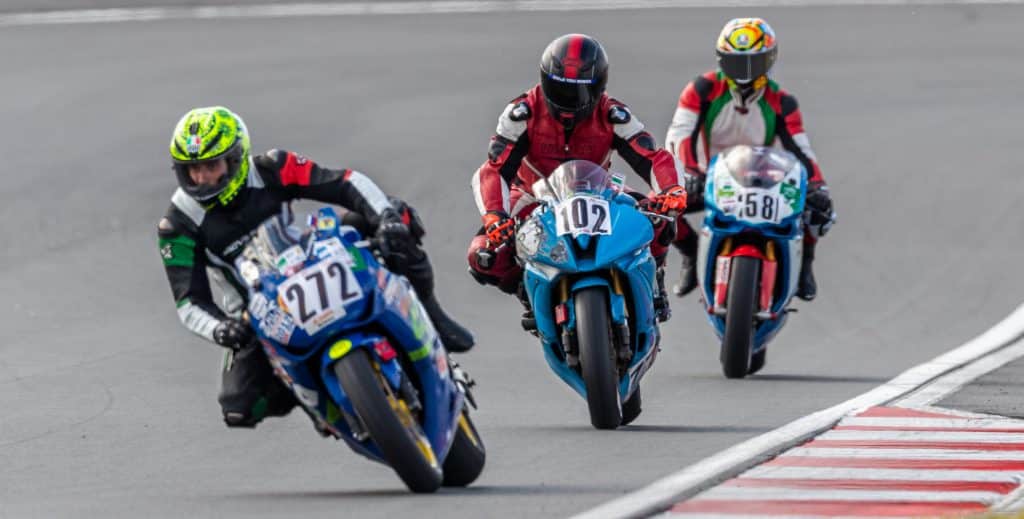 Is Riding a Sportbike Uncomfortable? My 8 Pro Tips for a Better Ride! Faster cornering and lap times, as demonstrated by Denis taking an early lead into the first turn at Pertamina Mandalika International Street Circuit, Lombok, Indonesia.