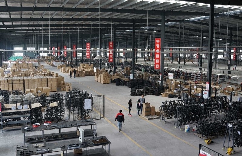 Chongqing Fuego Power Co., Ltd., manufacturers of the Tekken 250 motorcycle, workshop in China with a bustling, busy atmosphere.