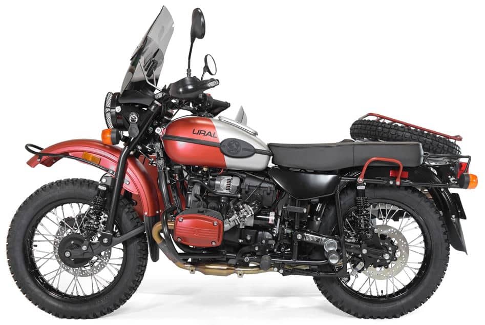 Which Heavyweight Motorcycles Have Reverse Gear? Top 6 Picks Ural Gear Up showcasing its rugged design with selectable two-wheel drive for both the rear and sidecar, a five-speed gearbox including reverse, and distinctive military-style features like a universal spare wheel, jerry can, and folding utility shovel. The leading link front suspension highlights its off-road capabilities.