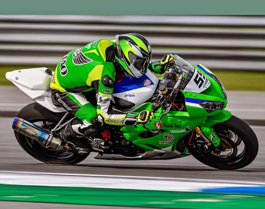 CE Motorcycle Race Suit Standards: EN 17092-1:2020 Buyers' Guide Aden Thao demonstrates the AGVSPORT FIM-homologated suit’s dynamic performance during a high-speed corner, highlighting verified stretch zone efficiency, maintained armor positioning, and certified flexibility under professional racing demands.