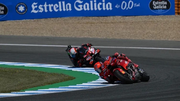 Marquez leaning hard, elbow or knee down, showing his signature aggressive style.