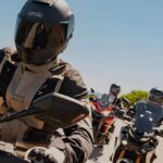 Three riders wearing Cardo BEYOND GT and GTS helmets showing integrated mesh intercom modules, 53 mm speakers, and aerodynamic shell design.